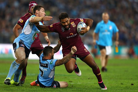 Sam Thaiday of the Maroons is tackled.