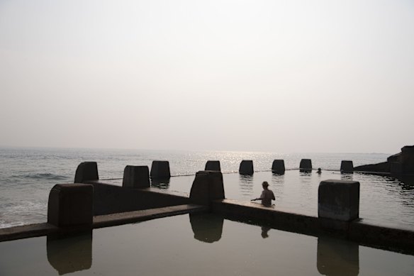 Coogee baths against the smoky sky.