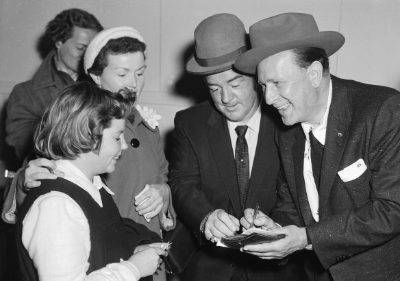 US actors and comedians Bud Abbott (right) and Lou Costello meet some fans upon their arrival at Sydney's Mascot Airport on 15 June 1955 for a series of shows.