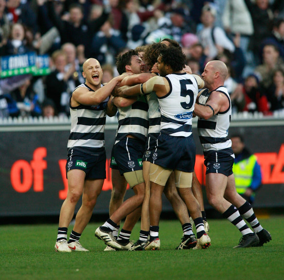 Geelong players mob Jimmy Bartel after his winning point in 2009.