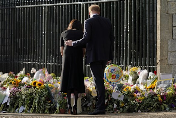 Britain's Prince Harry and Meghan, Duchess of Sussex, view the floral tributes for the late Queen Elizabeth II.