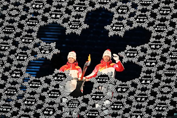 The scintillating opening ceremony ended with a member of China’s Uighur minority - whose treatment is the focus of international human rights criticism - helping to light the Olympic cauldron.