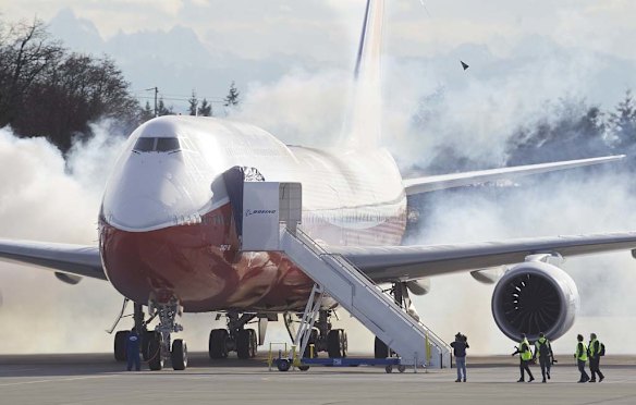 The Boeing 747-8 Intercontinental airliner, the company's newest and largest passenger plane, starts its engines on the runway before it takes off for its first test flight.