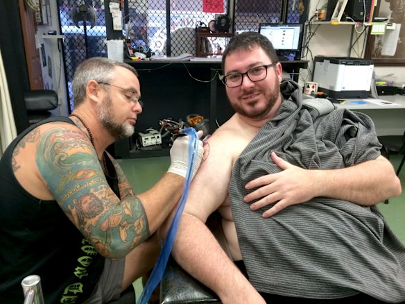 Mr Christensen is given his Coptic Madonna tattoo by Dave Phare from Mad Monk Tattoos in Mackay. 