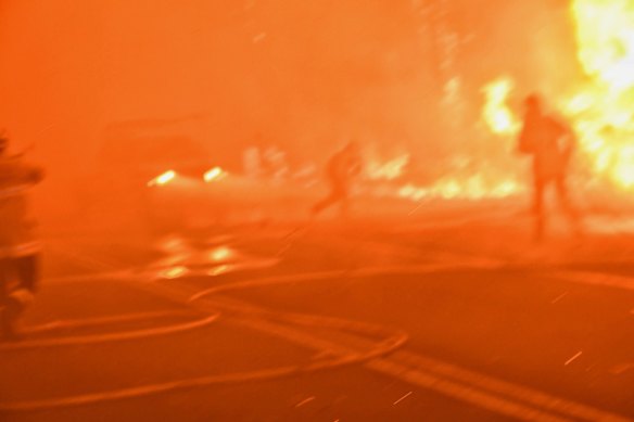 Firefighter a second after being hit by a car in thick smoke as fire roared through eastern Bilpin, December 21, 2019.