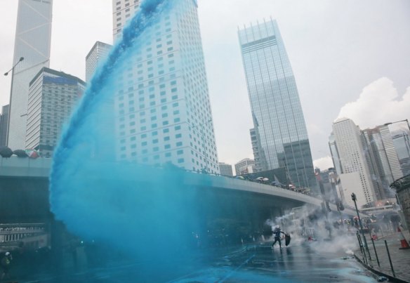 Police fire blue-coloured water from water cannons at protesters in central Hong Kong.