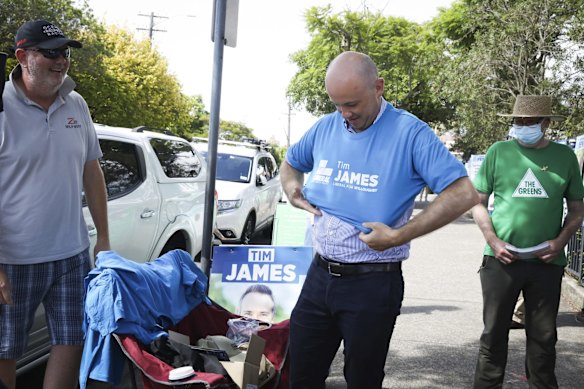 NSW Treasurer Matt Keen dons a campaign shirt to support Liberal candidate Tim James during the Willoughby byelection.