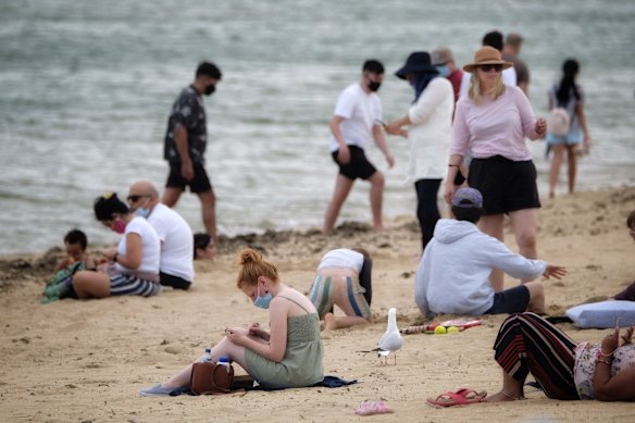 People enjoying the warm weather at St Kilda Beach, Saturday 3 October 2020.