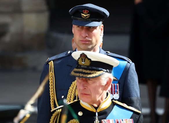 King Charles III and Prince William, Prince of Wales look on as the procession makes its way through London.