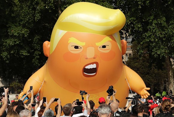 A six-metre high cartoon baby blimp of U.S. President Donald Trump is flown as a protest against his visit, in Parliament Square in London, England, Friday, July 13, 2018.