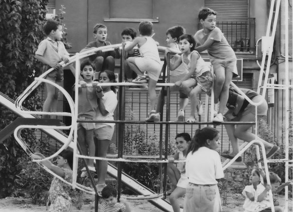 Happiness is a crowded climbing frame: Max Naglazas (back to the camera) fights for a space in a park in Hospitalet de Llobregat.