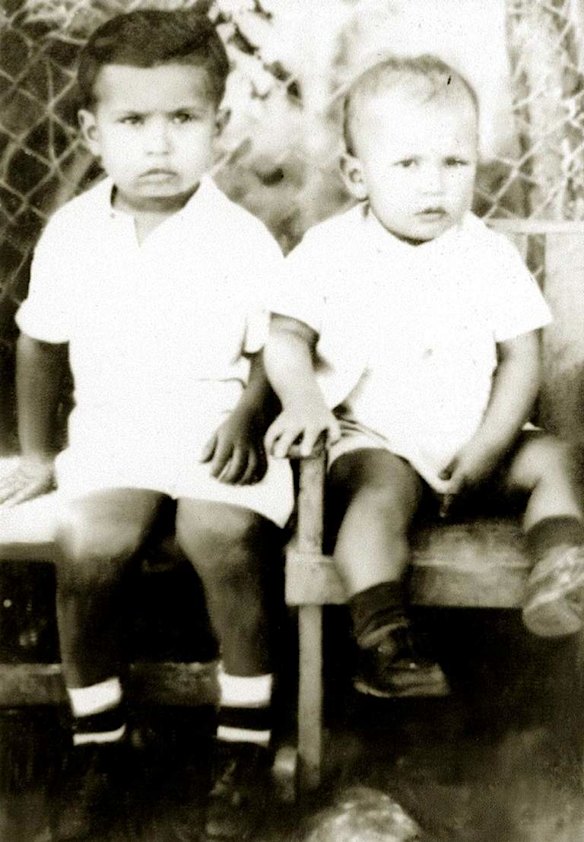In this undated photo released by Miraflores Press Office, Hugo Chavez, right, sits with his brother Adam in Barinas, Venezuela.