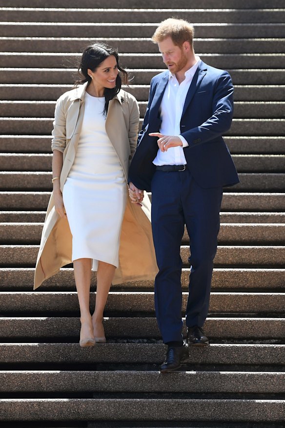 Britain's Prince Harry, the Duke of Sussex, and his wife Meghan, the Duchess of Sussex, arrive for a the meet the people walk at the Sydney Opera House in Sydney, Australia, Tuesday, October 16, 2018. The Duke and Duchess of Sussex are on a 3-week tour of Australia, New Zealand, Tonga, and Fiji and are in Sydney to launch the 2018 Invictus Games, an Olympic-style event for disabled and ill service people. (AAP Image/Joel Carrett) NO ARCHIVING