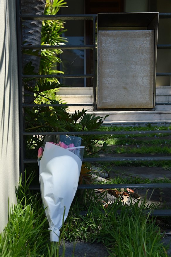 A bunch of flowers at the fence of the Dover Heights home of Anthony Koletti, Melissa Caddick and her 15 year old son. Melissa Caddick is presumed dead after remains were found at Bournda Beach on the South Coast of NSW.