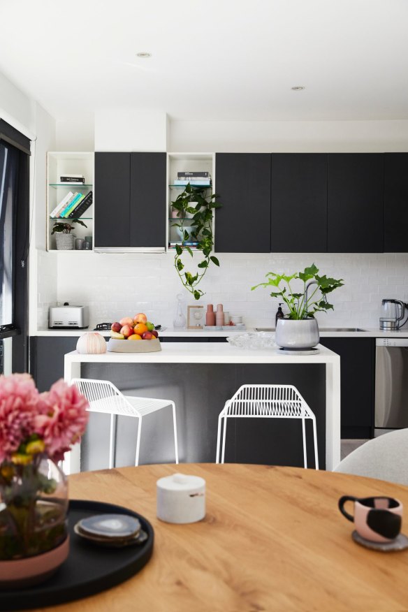 “Downstairs was transformed when we lime-washed the floors and painted the cabinets from a brown wood-grain to this striking black,” says Annaliese.
