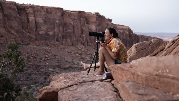 Photographer Krystle Wright takes stationary images of her lighting design on a Long Canyon cliff face.