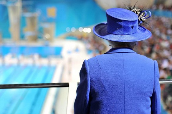 Queen Elizabeth watches the morning session of the swimming at the aquatics centre during her visit to the London 2012 Olympic Games.    Photo by Reuters