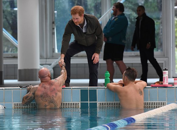 Prince Harry meets defence veteran swimmers and tours Sydney International Aquatic centre. 