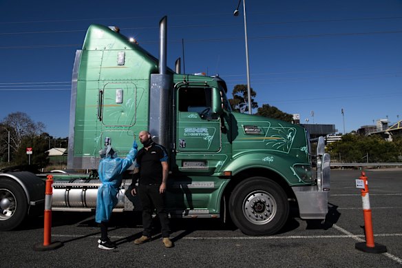 Truck driver Mick Cummings having a COVID test at the Leumeah Drive through COVID-19 testing clinic. He works at a truck depot in Campbelltown and lives in the Southern Highlands, and is required to have a COVID test every three days.