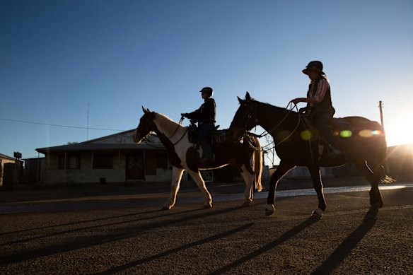 Horse riders travel down the main street in Tibooburra, in the far north-west of NSW. Nearby Narriearra Homestead has been purchased by the NSW Government to become a new National Park. 