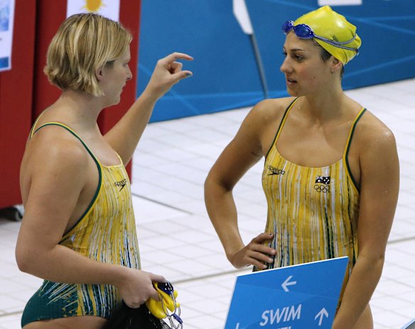 Leisel Jones and teammate Stephanie Rice  talk during a training session.