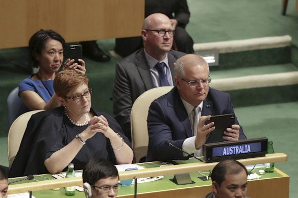 Prime Minister Scott Morrison raises his mobile phone as President of the United States Donald Trump arrives to speak during the United Nations General Assembly meeting in New York.