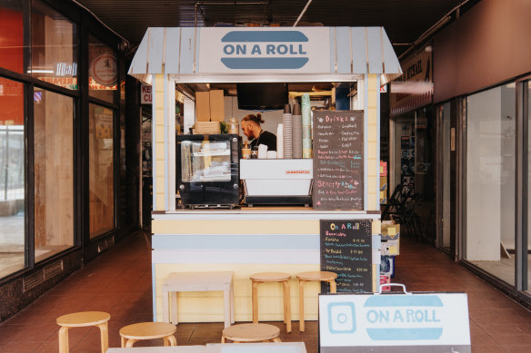 On a Roll sits in the middle of the narrow arcade that includes a nail bar, hairdresser, shoe repairer and vacant shops.