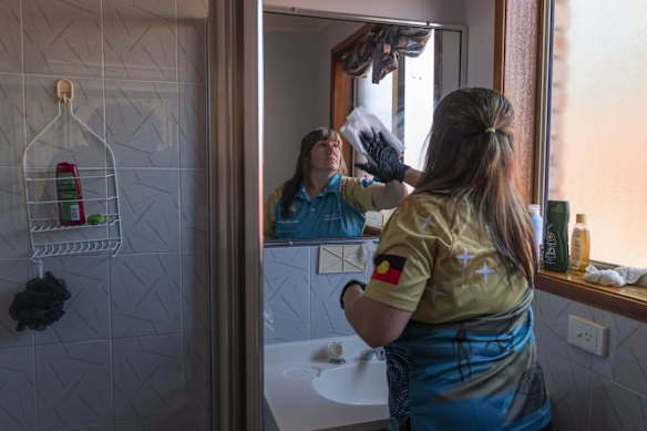 Booraja Home Care worker Narelle Welsh, cleaning Norman Russell's bathroom in Broulee.