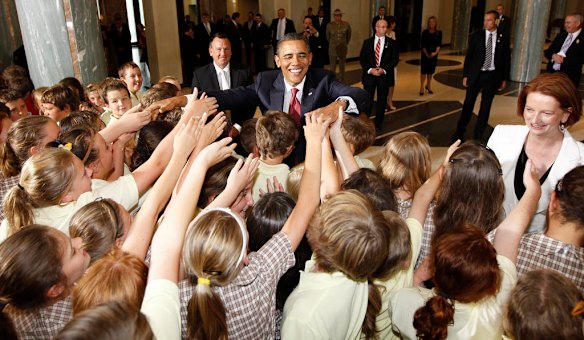 U.S. President Barack Obama and Australian Prime Minister Julia Gillard, right, greet students gathered at Parliament House in Canberra, Australia.