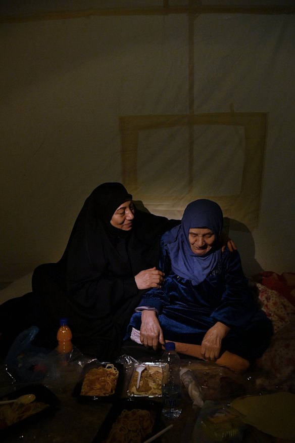 Zahra Issa with her 90-year-old mother Um Ahmad inside their tent at the al Zarif Intermediate School, now a shelter for more than 1200 displaced people in West Beirut.