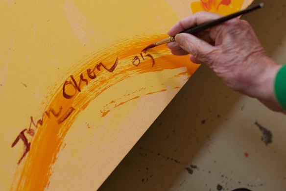 John Olsen signs his work.
