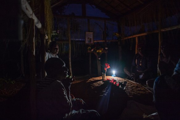 A family at Pastor Edobo Ban's grave site in Mougulu. He died recently from Liver Cirrhosis, Hepatitis B infection. 