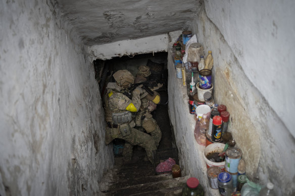Ukrainian National Guard soldiers inspect a basement during a reconnaissance mission in a recently retaken village on the outskirts of Kharkiv, east Ukraine.