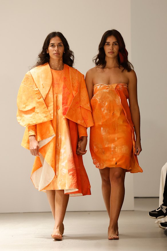 Models returned to the runway after a fire alarm emptied the crowd from the gallery for 15 minutes.