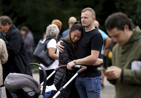 Mourners gather to pay their respects at Windsor Castle, following Thursday's death of Queen Elizabeth II, Friday Sept. 9, 2022.