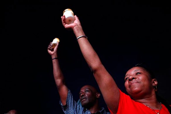 People hold candles in front of the Apollo Theater while paying tribute to the late pop icon Michael Jackson in New York June 25, 2009.