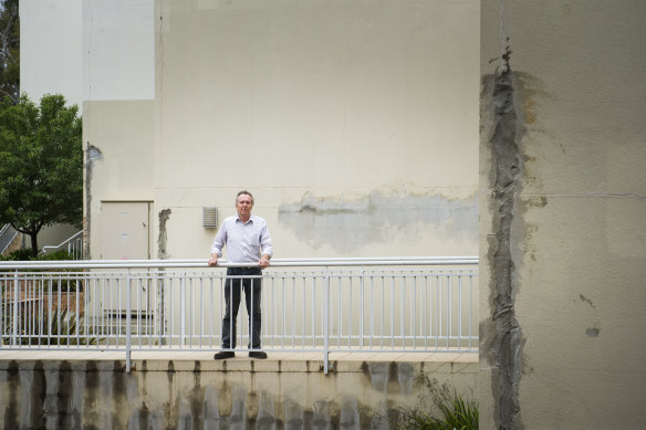 A review of the Elara building, pictured above with apartment owner David Allen, revealed "systemic design practices" which had resulted in defects, according to the structural engineer who conducted it.