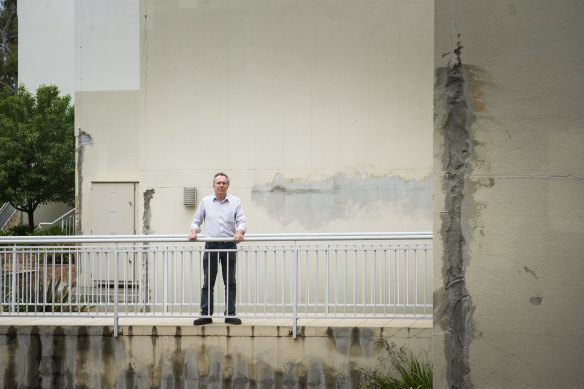 Damage alleged to have been caused by water leaks at the Elara complex. Dave Allen is pictured at the site.