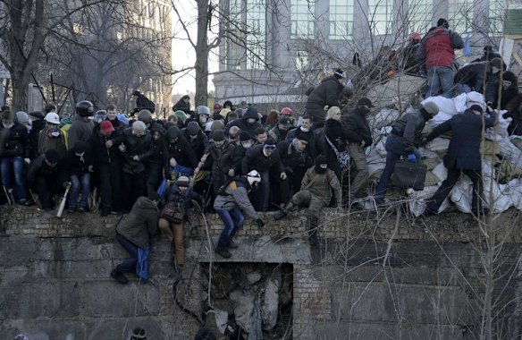 A crowd spreads out as riot police attack anti-government protesters during clashes in Kiev, February 18, 2014. Ukrainian riot police advanced on the heart of 12-week-old protests against President Viktor Yanukovich on Tuesday and security forces set a deadline to end disturbances after at least five protesters were reported killed in a day of clashes.