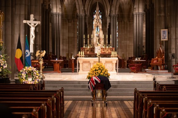 Bert's coffin was draped in the Australian flag, which lay beneath a. mound of yellow roses. 