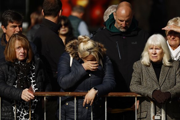 BALLATER, ABERDEENSHIRE - SEPTEMBER 11: People gather in tribute as the cortege carrying the coffin of the late Queen Elizabeth II passes by on September 11, 2022 in Ballater, United Kingdom. Elizabeth Alexandra Mary Windsor was born in Bruton Street, Mayfair, London on 21 April 1926. She married Prince Philip in 1947 and ascended the throne of the United Kingdom and Commonwealth on 6 February 1952 after the death of her Father, King George VI. Queen Elizabeth II died at Balmoral Castle in Scotland on September 8, 2022, and is succeeded by her eldest son, King Charles III. (Photo by Jeff J Mitchell/Getty Images)