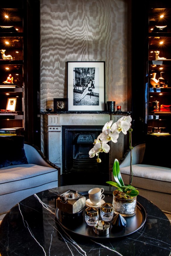 The Giorgio Armani watered silk fabric above the waitingroom fireplace extends across the ceiling