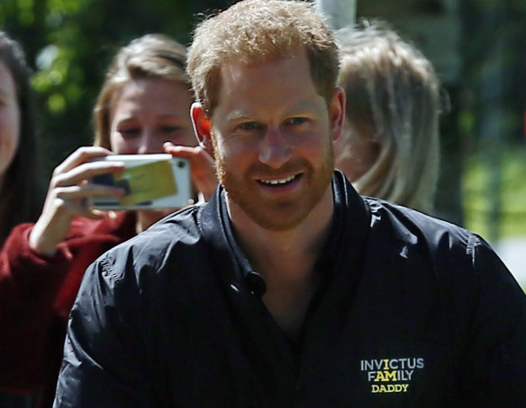 Prince Harry wears a jumper reading 'Invictus Family: I am daddy' which was given to him during the launch of the next Invictus games in The Hague, Netherlands, Thursday, May 9, 2019. 