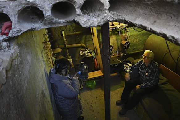 Liudmyla Pavliuk (left) and her husband Mykhaylo Pavliuk wait in their backyard bomb shelter in Krasnohorivka. Liudmyla is the head of the administration in charge of several villages.