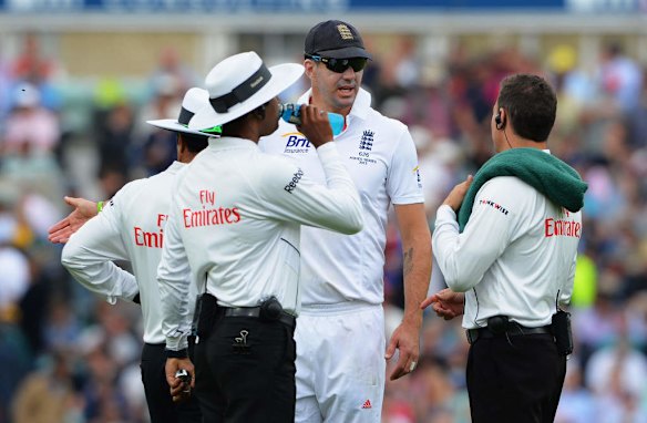 Kevin Pietersen of England talks to the umpires.