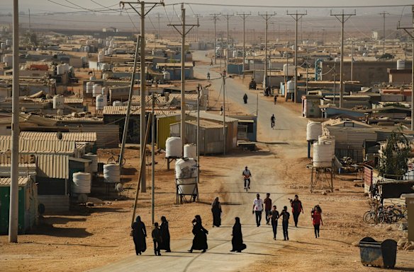 People walk down a road in Zaatari Camp in Jordan. According to UNHCR as of February 2018 Zaatari camp is home to 78,994 Syrian refugees and nearly 20% are under the age of 5 and there is an average of 80 births a week. Jordan is one of the 4 countries that has taken in a majority of Syrians fleeing the war.