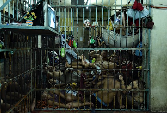 Prisoners rotate positions within an overcrowded cell in order to get some sleep. 