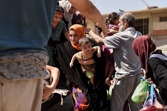Families arrive at a screening point in West Mosul.