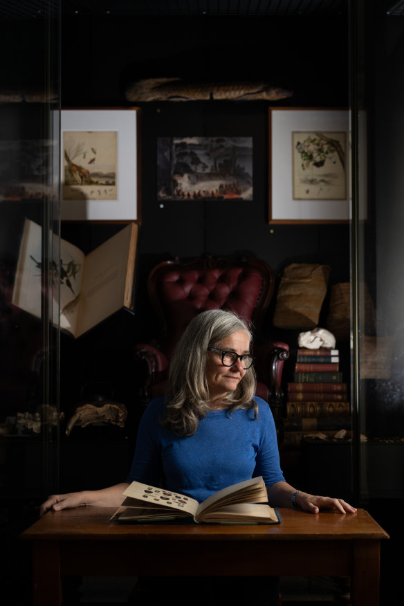 Australian Museum curator Vanessa Finney with the red chair that Krefft was carried out in.