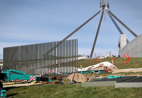 A security fence is installed across the lawns of Parliament House in Canberra on Tuesday.